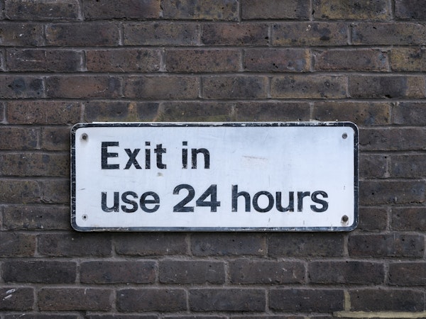 Sign board on brick wall