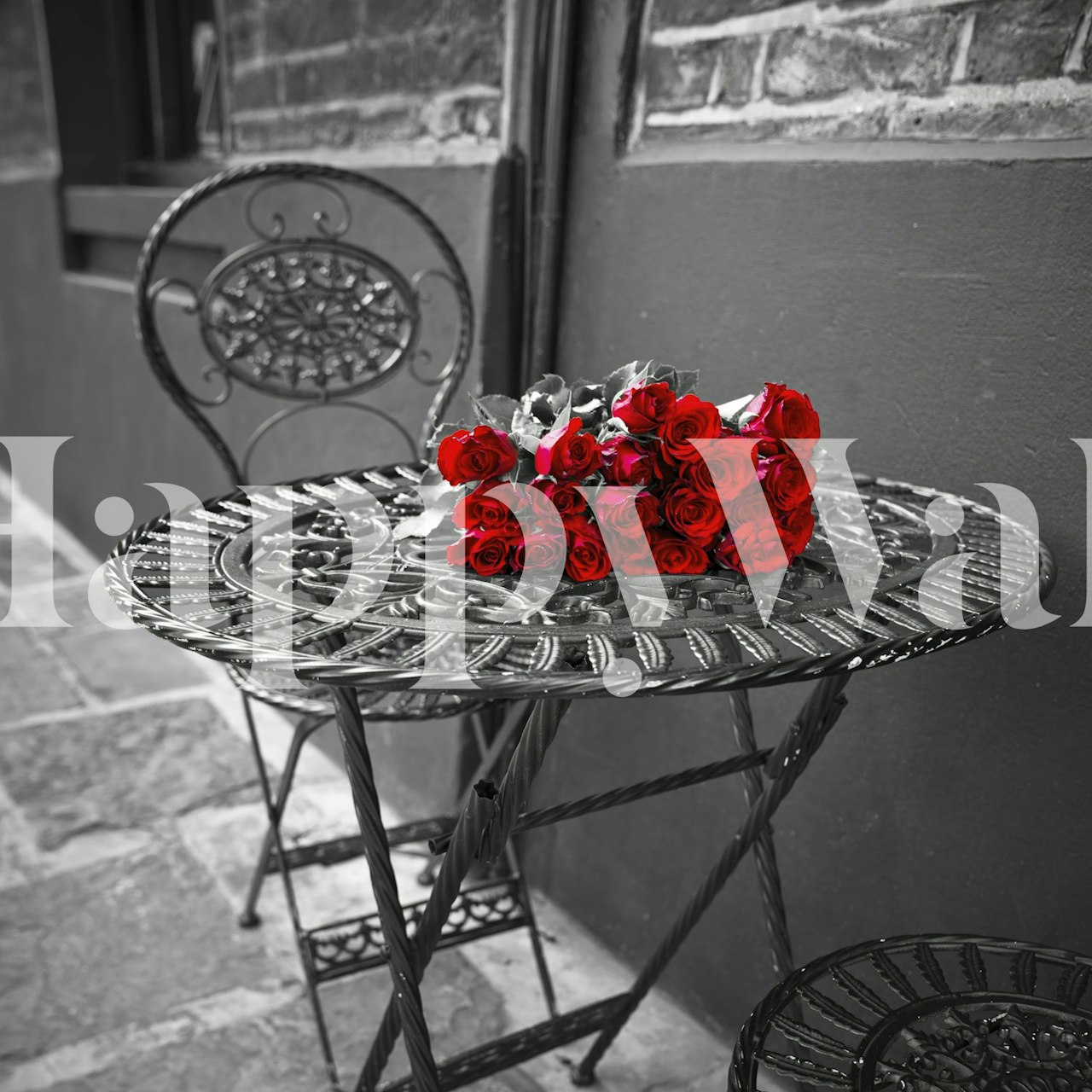 Red roses on wrought-iron table against black and white background wall mural