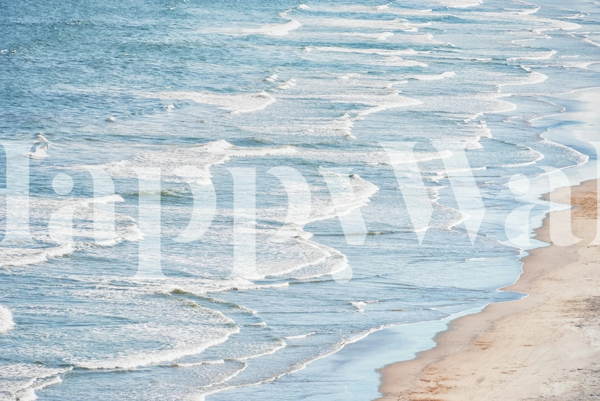 Ocean waves on sandy beach in soft blue tones wallpaper