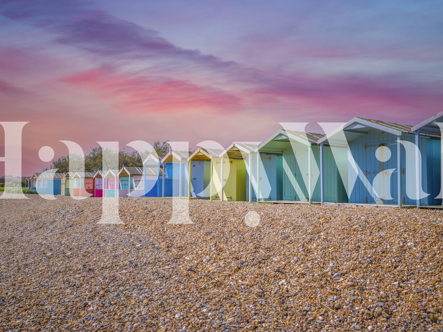 Colorful beach huts on a pebble beach with sunset sky wall mural