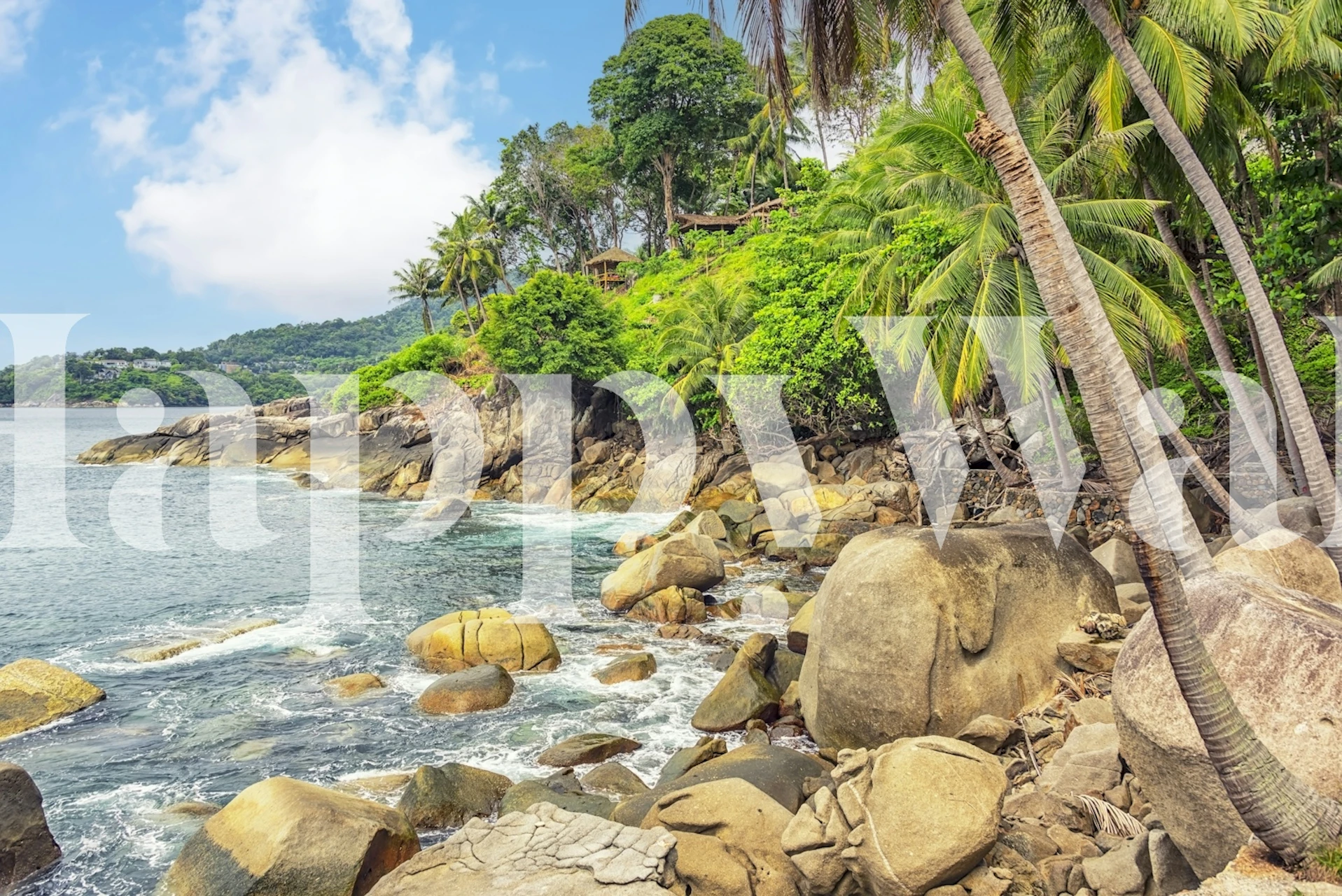 Tropical rocky shoreline with vibrant green trees and blue water wallpaper
