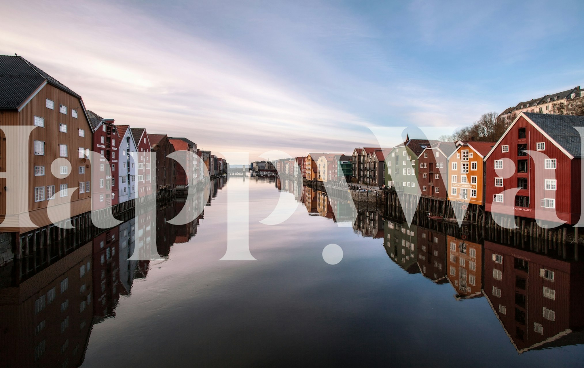 Colorful river view of Trondheim with reflected buildings on water wallpaper