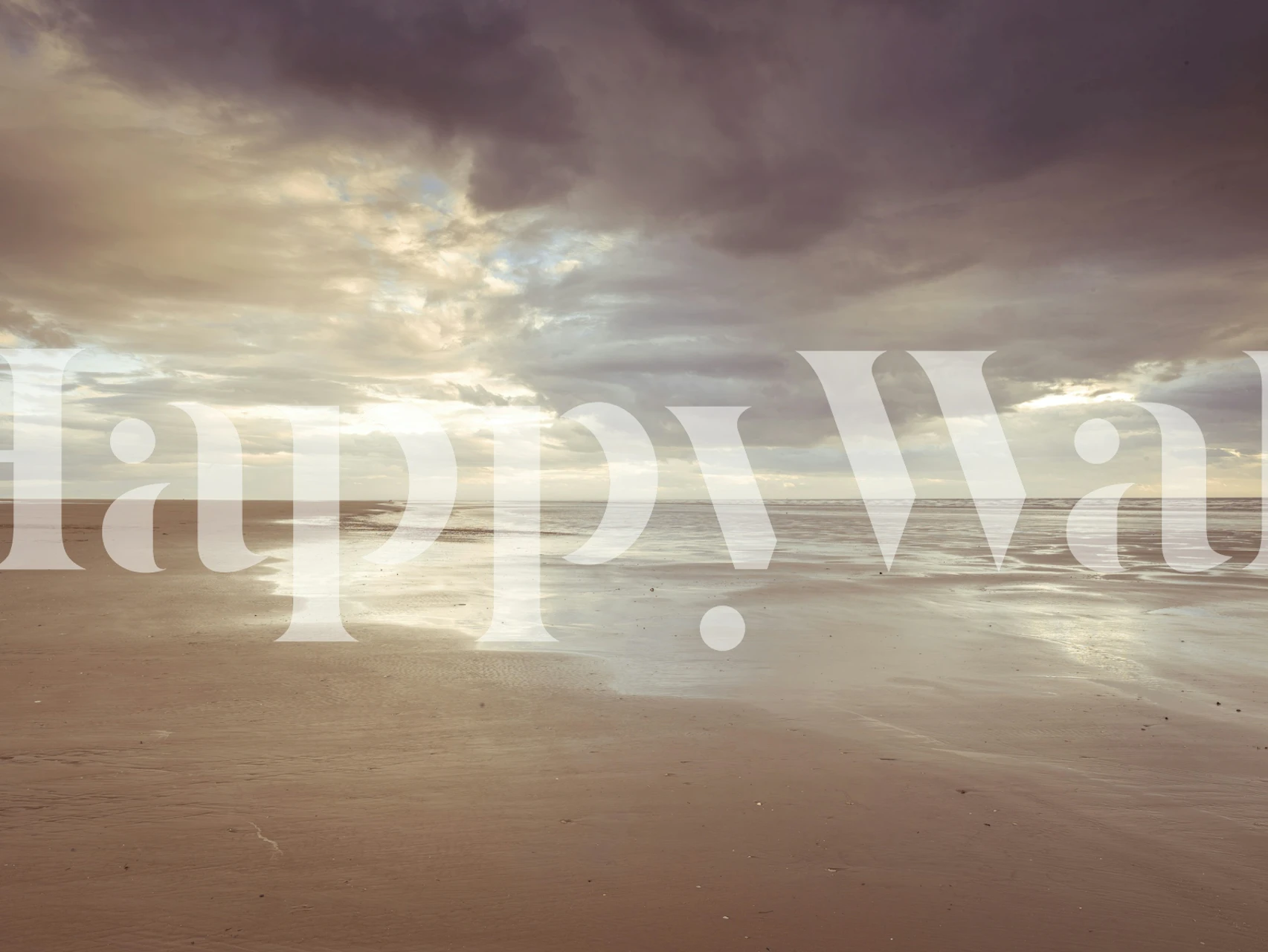 Beach landscape with cloudy sky and sandy shore wallpaper