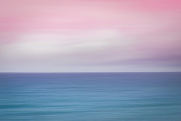 Serene blurred sky and ocean at sunset