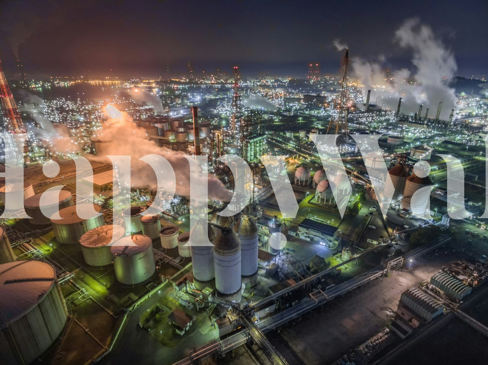 Night view of an industrial area with glowing lights and smoke, abstract wallpaper