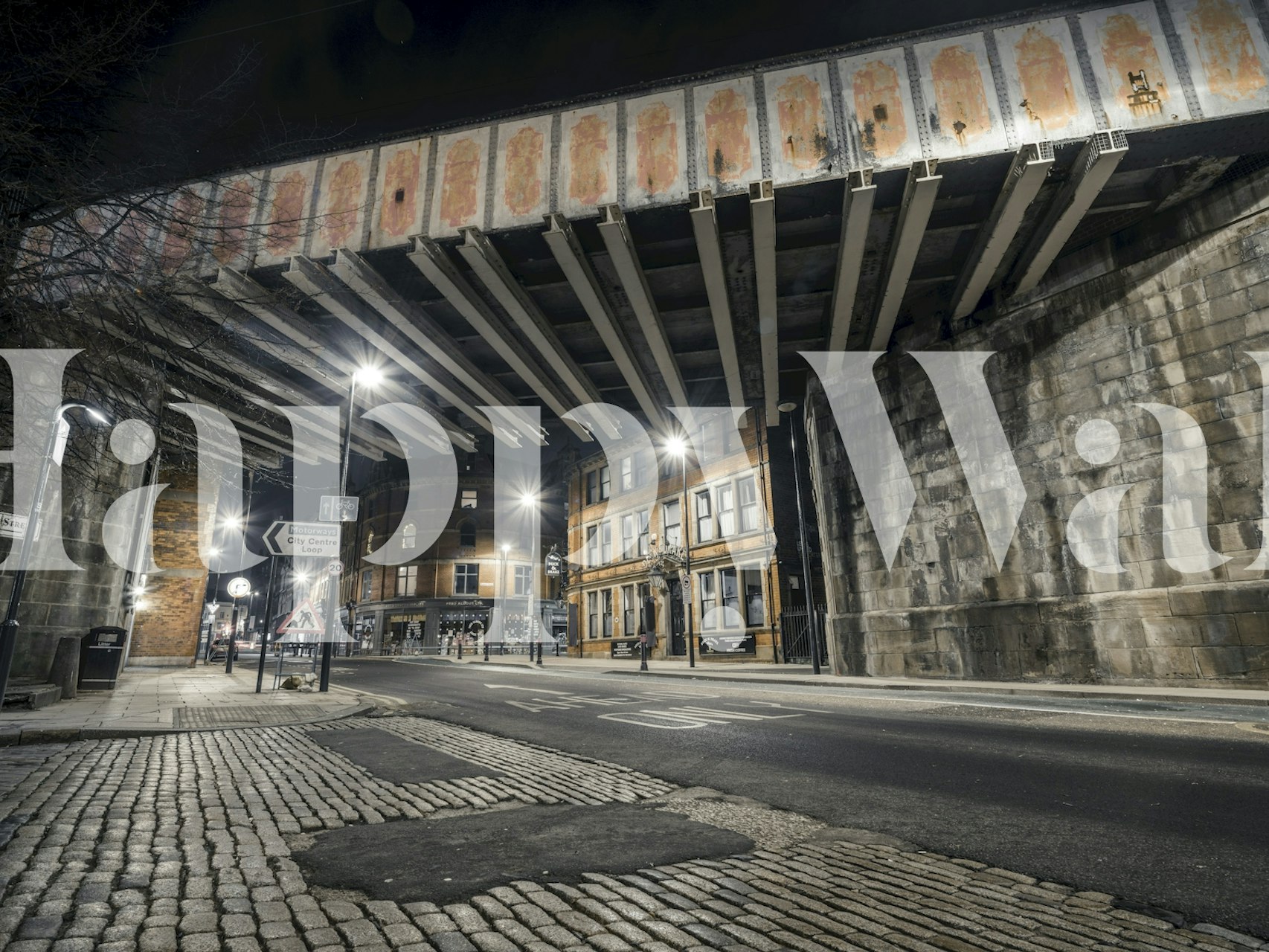 Urban street at night with underpass and buildings wallpaper
