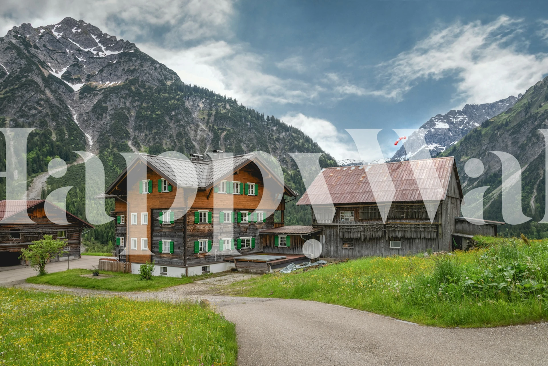 Mountain lodge scene with green accents and rustic buildings wallpaper