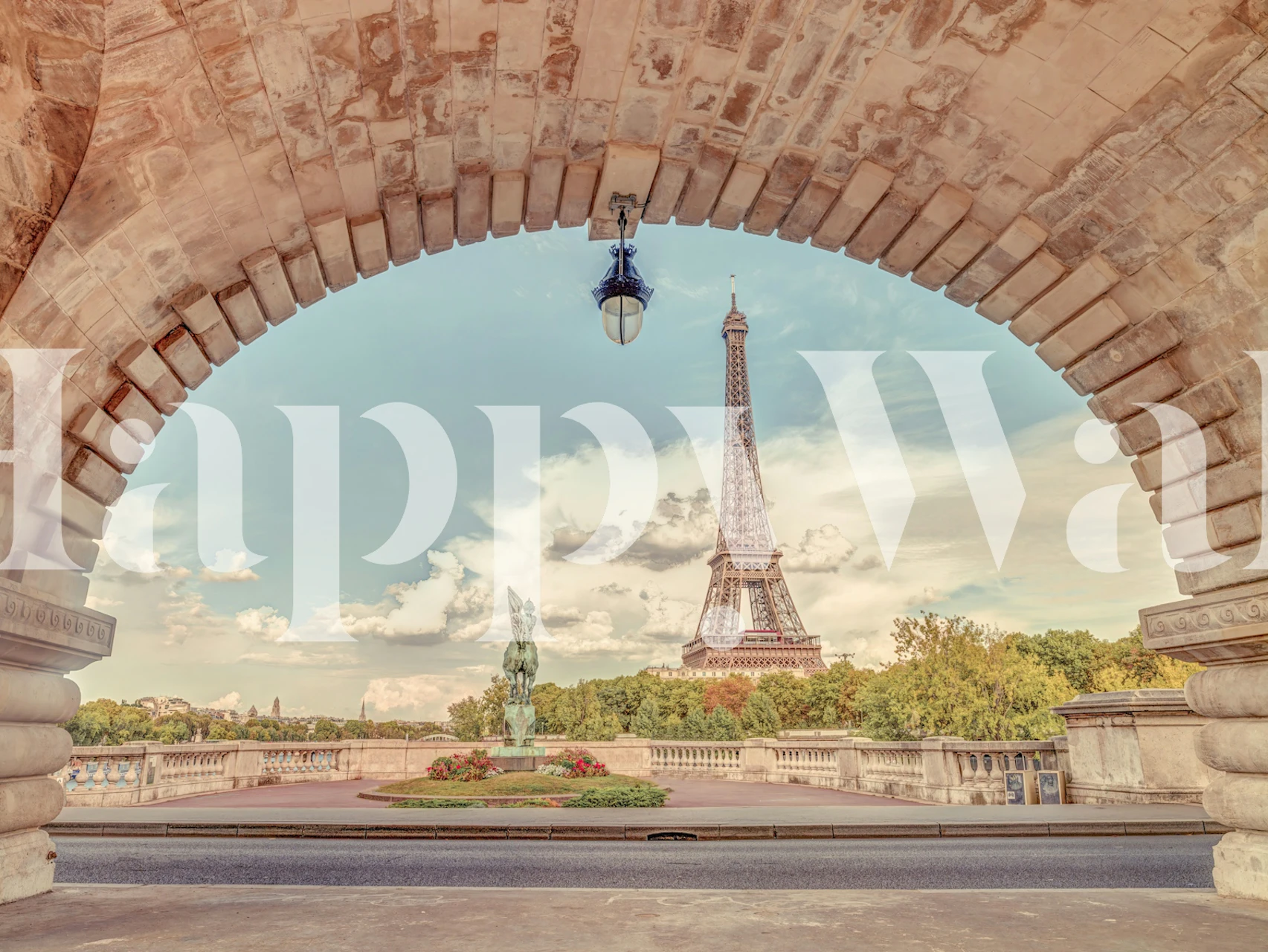Eiffel Tower seen through an arch with green trees in the background, stunning wallpaper
