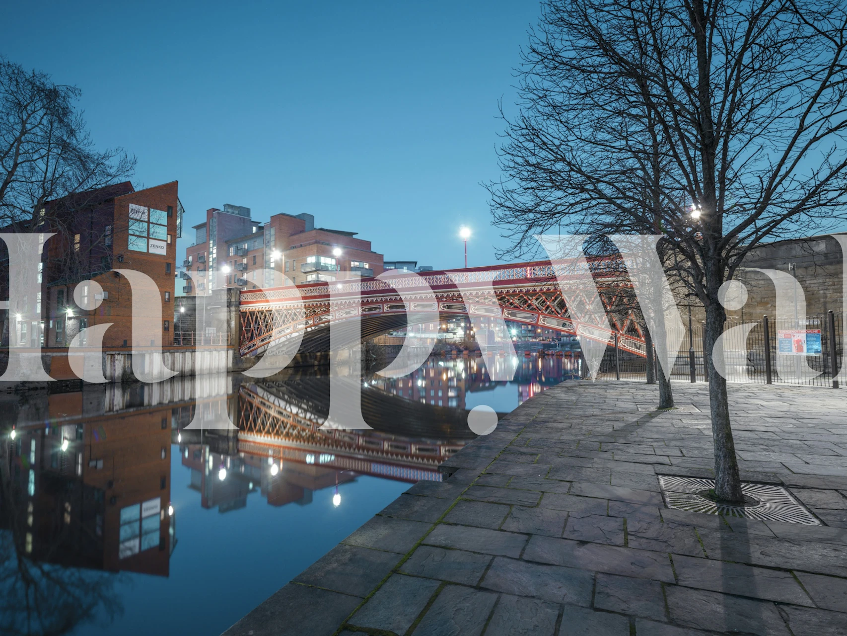 Cityscape at night with illuminated bridge and water reflections wallpaper