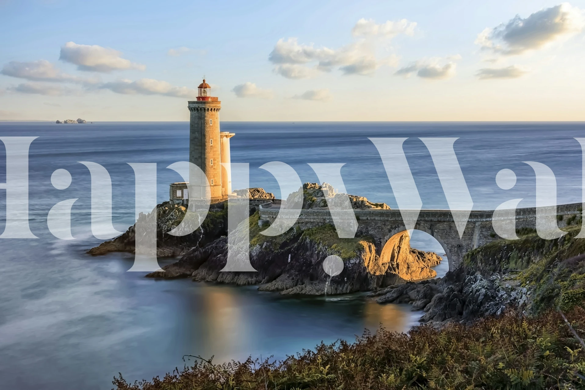 A lighthouse by the sea during sunset, featuring warm tones and calm water wallpaper