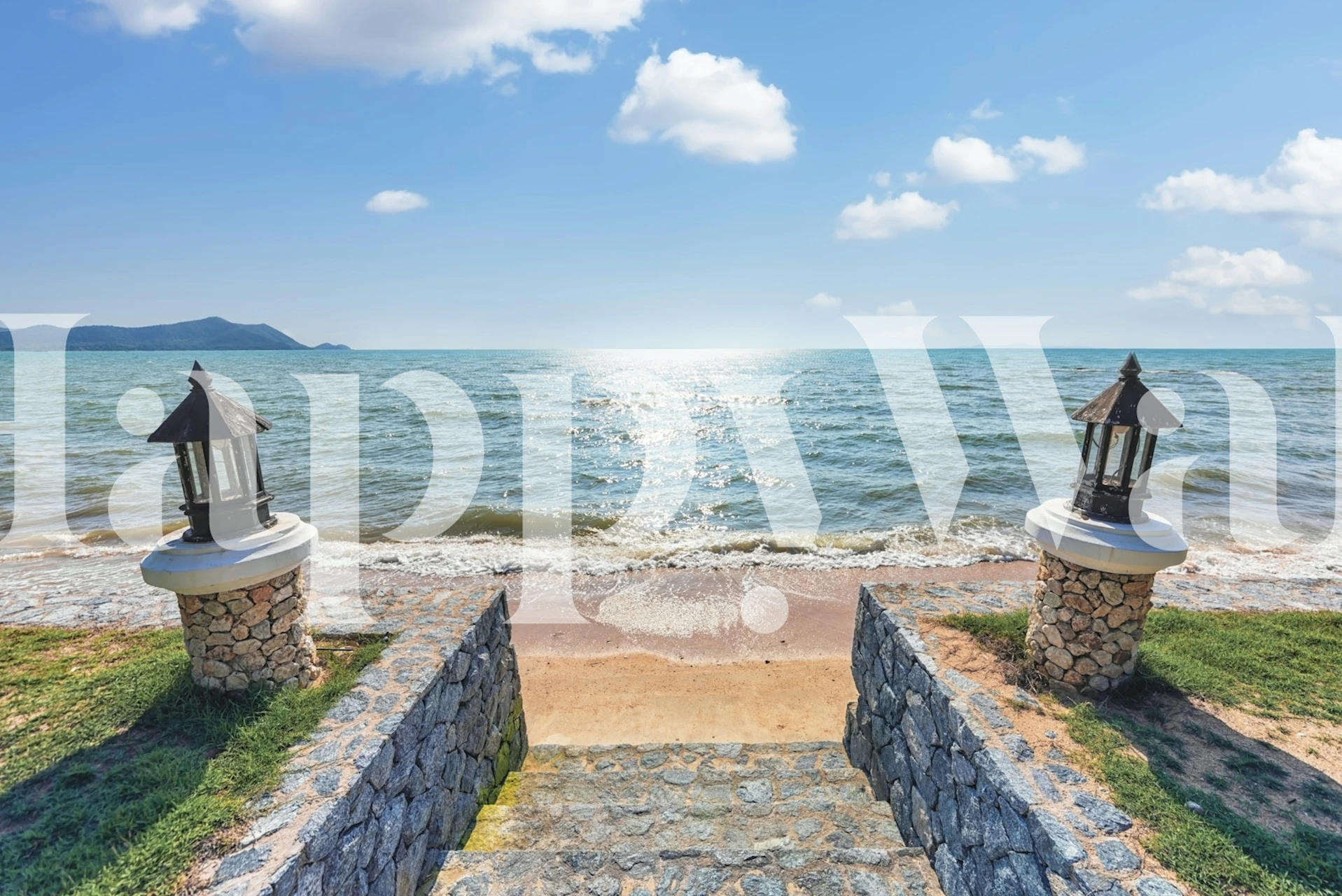 Scenic beach view with blue sea, sandy shore, and lanterns wallpaper