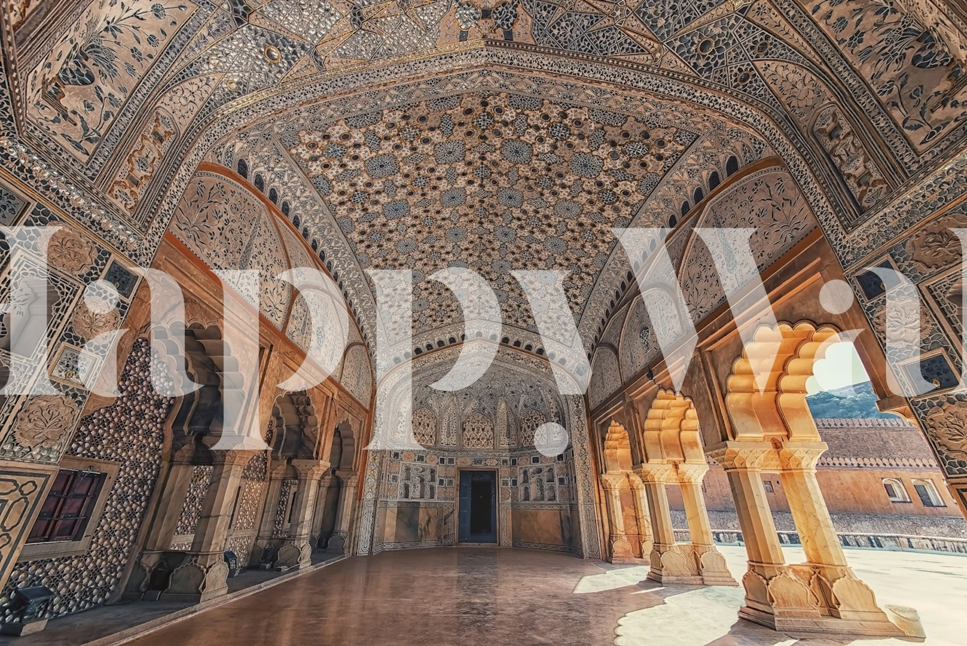 Intricate Amber Fort architecture in gold and beige wallpaper