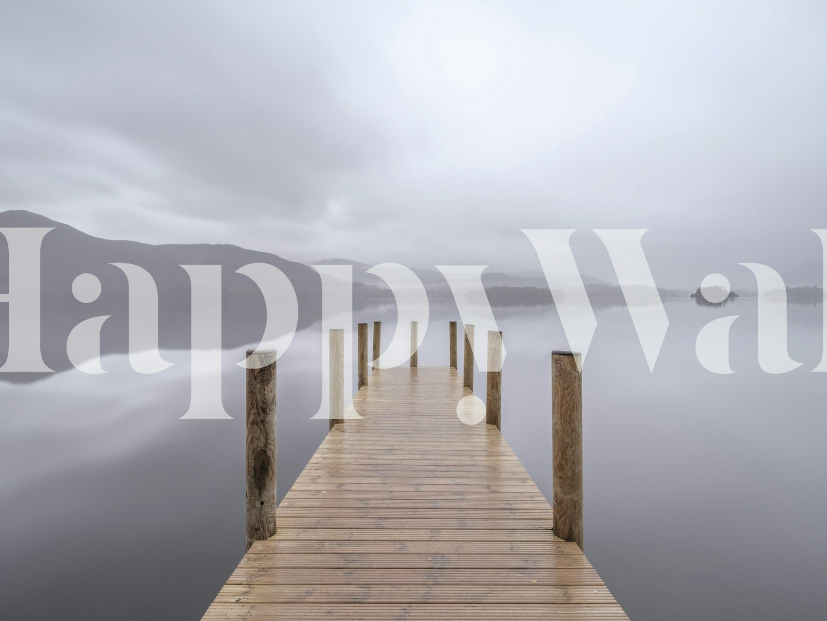 Wooden pier extending into calm lake with grey sky wallpaper