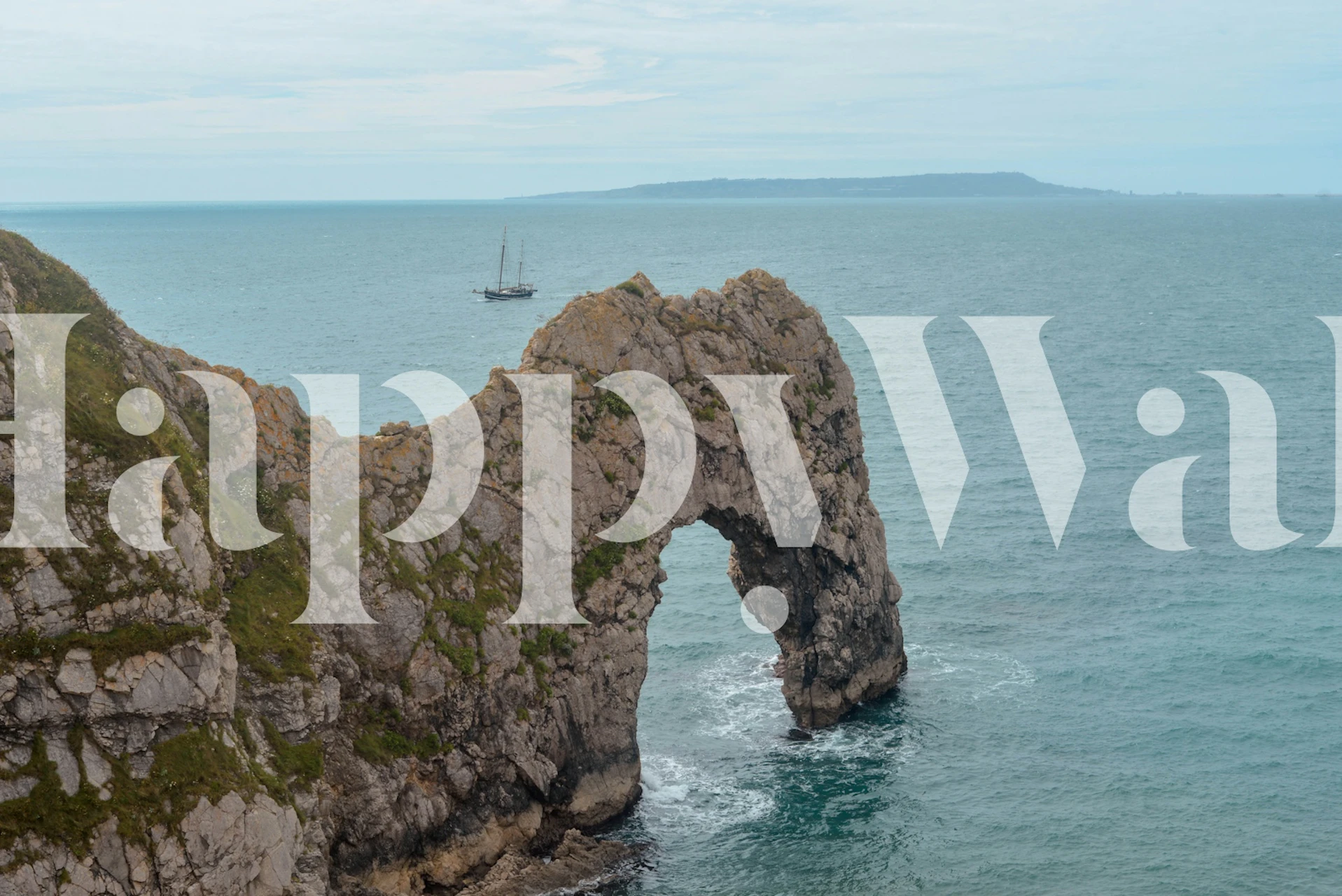 Coastal view wallpaper featuring Durdle Door rock arch and blue waters.