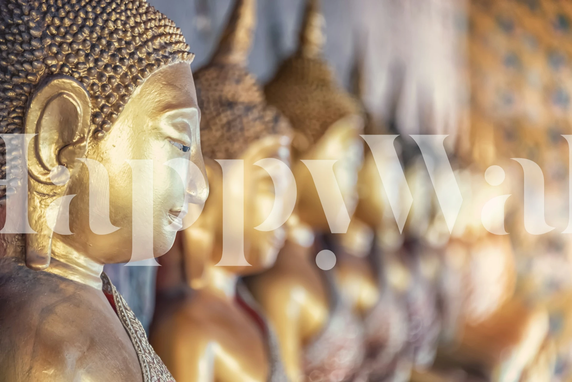 Golden Buddha sculptures in a row on a textured background wallpaper