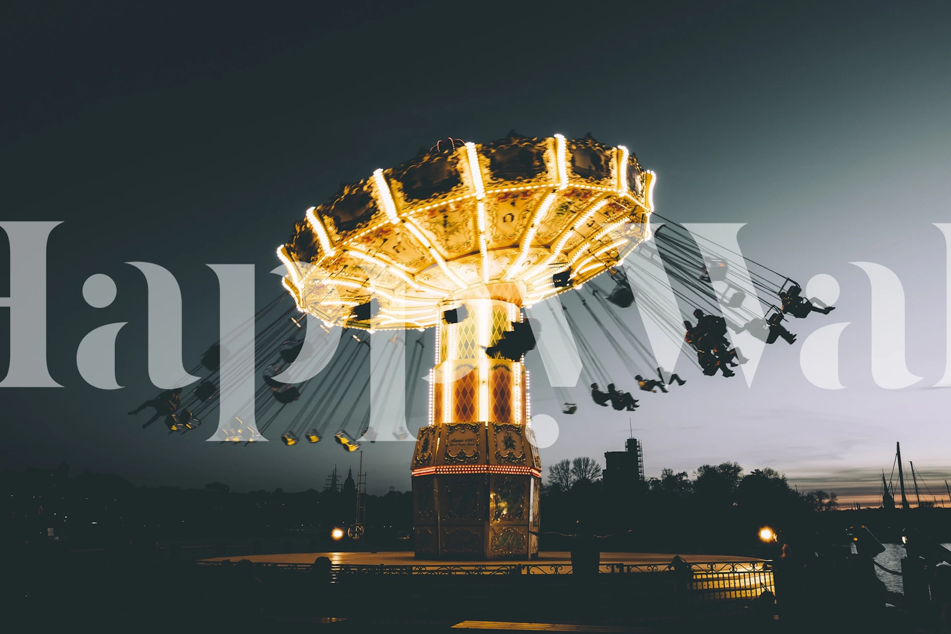 Carnival swing ride illuminated by lights at night wallpaper