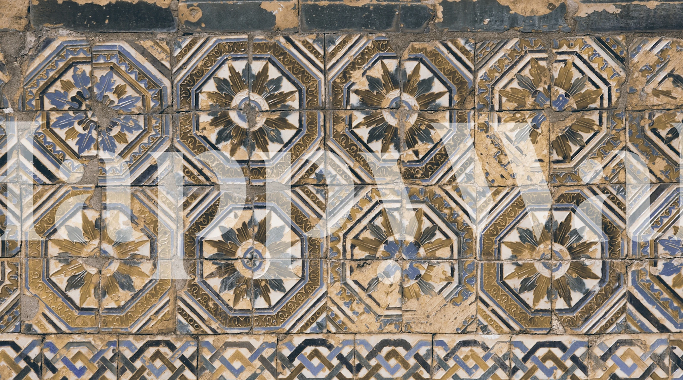 Old patterned tiles wall mural with intricate beige, gold, and blue designs